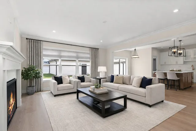 a living room with fireplace furniture and a large window