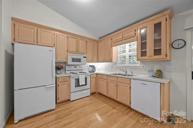 a kitchen with white cabinets and white appliances