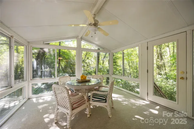 a dining room with furniture water view and a large window