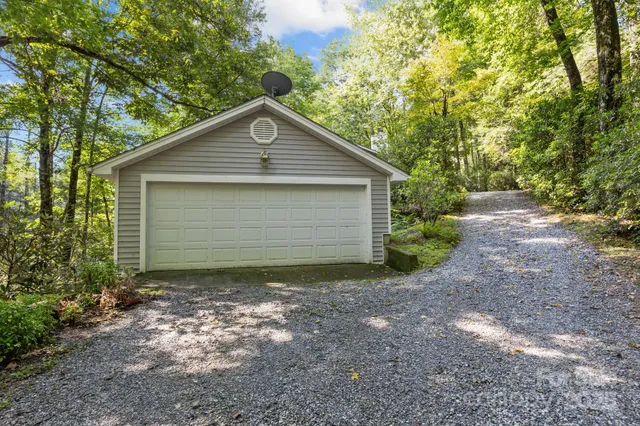 a view of house with backyard