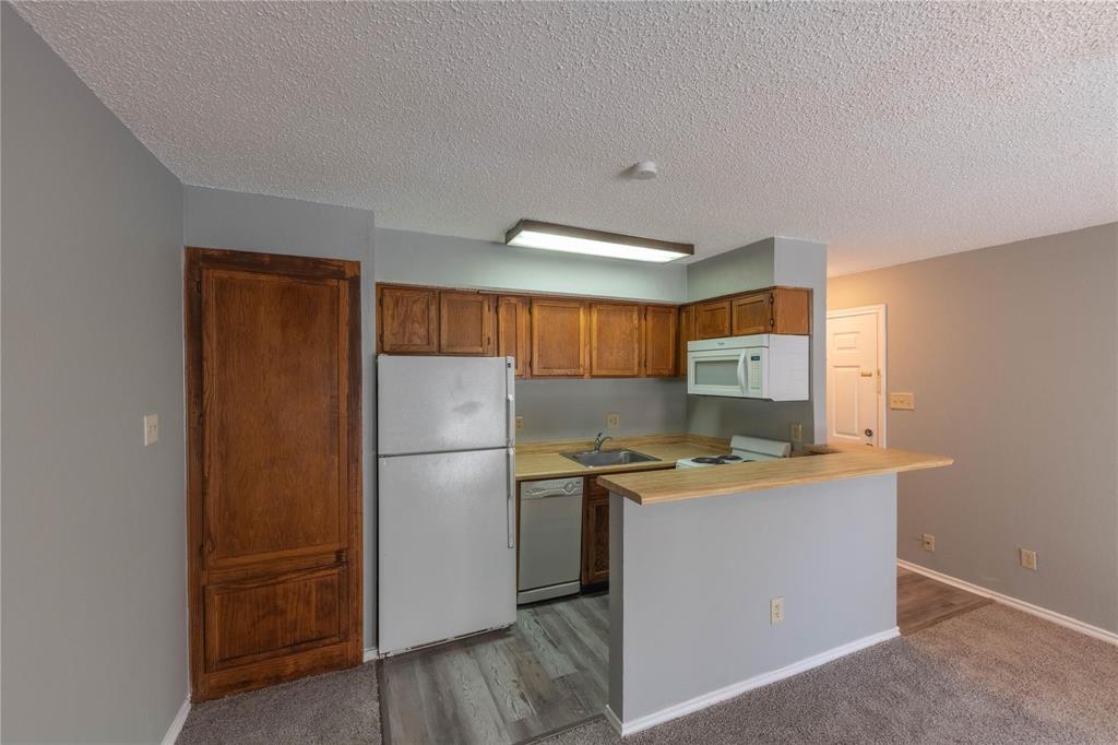 a kitchen with a refrigerator a stove a microwave and a refrigerator