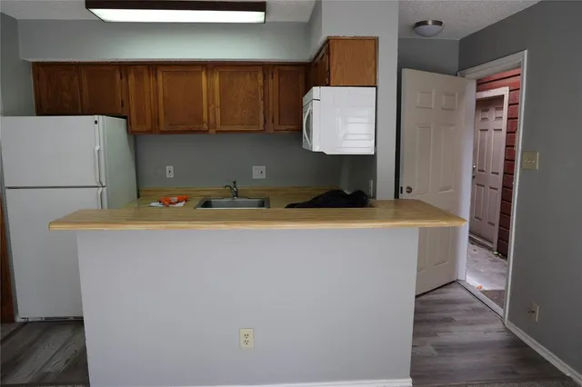 a room with cabinets and a refrigerator