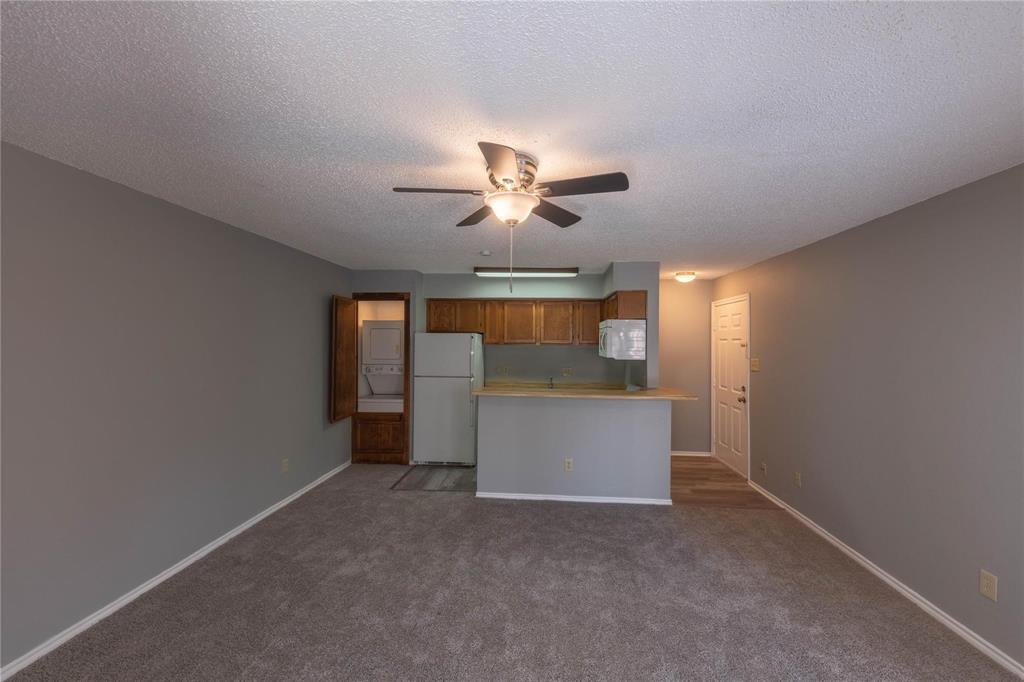 9805 Walnut Street, Unit 305C Dallas, TX 75243 - Photo 19 of 19 a view of an empty room and chandelier fan