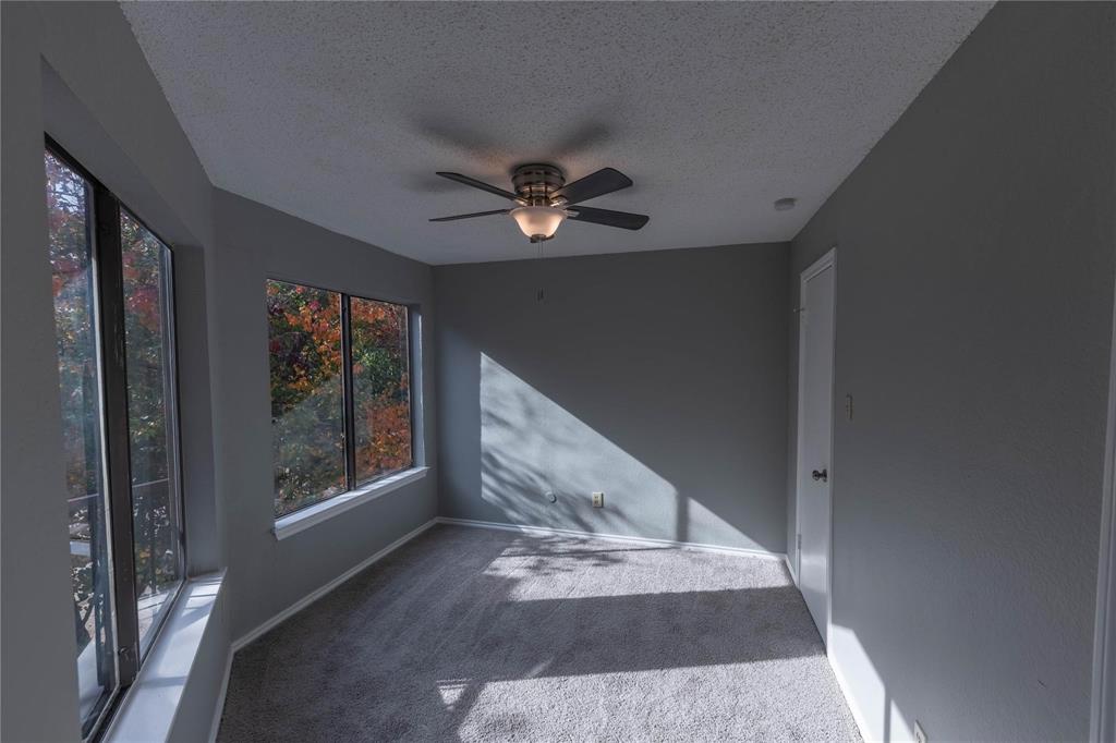 9805 Walnut Street, Unit 305C Dallas, TX 75243 - Photo 14 of 19 a view of an empty room with a fireplace