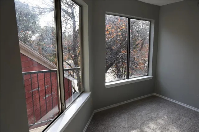 a view of an empty room with a fireplace