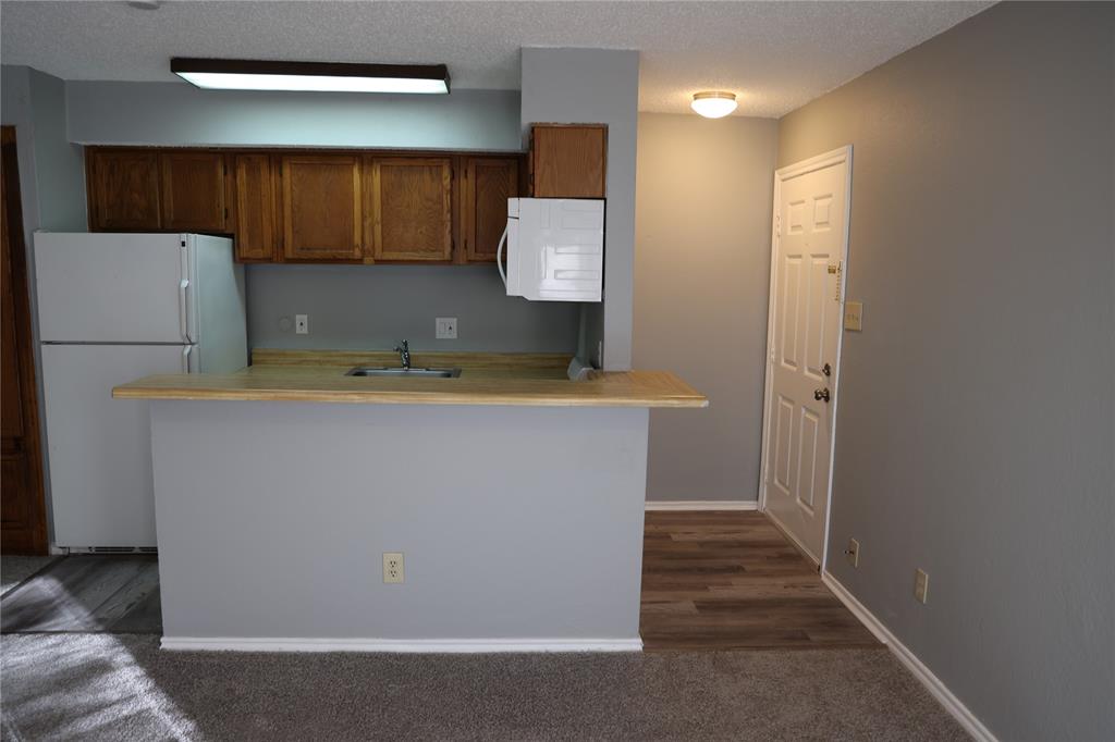 9805 Walnut Street, Unit 305C Dallas, TX 75243 - Photo 10 of 19 a utility room with a sink a washer and dryer