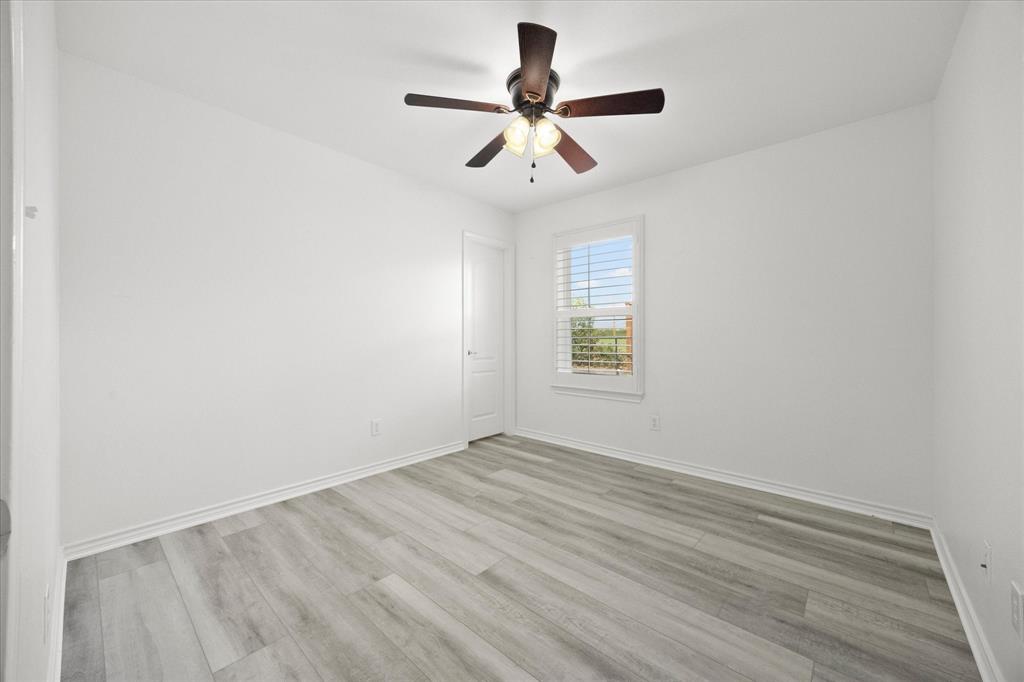 528 Hubbard Circle Nevada, TX 75173 - Photo 25 of 38 wooden floor in an empty room with a window