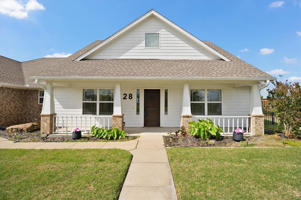 528 Hubbard Circle Nevada, TX 75173 - Photo 6 of 38 a front view of a house with a garden and plants