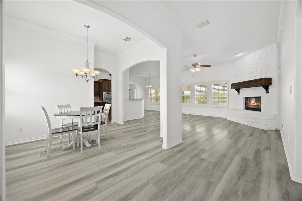 528 Hubbard Circle Nevada, TX 75173 - Photo 7 of 38 a view of a dining room with furniture wooden floor and a chandelier