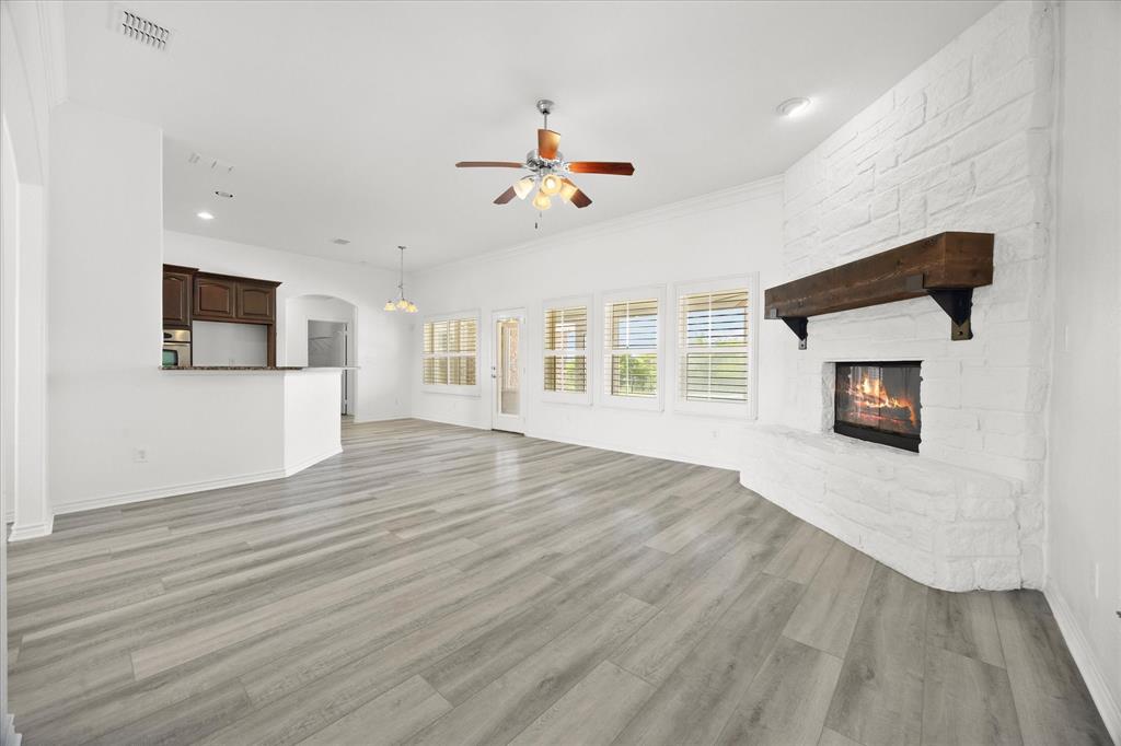 528 Hubbard Circle Nevada, TX 75173 - Photo 9 of 38 a view of a livingroom with wooden floor and a ceiling fan