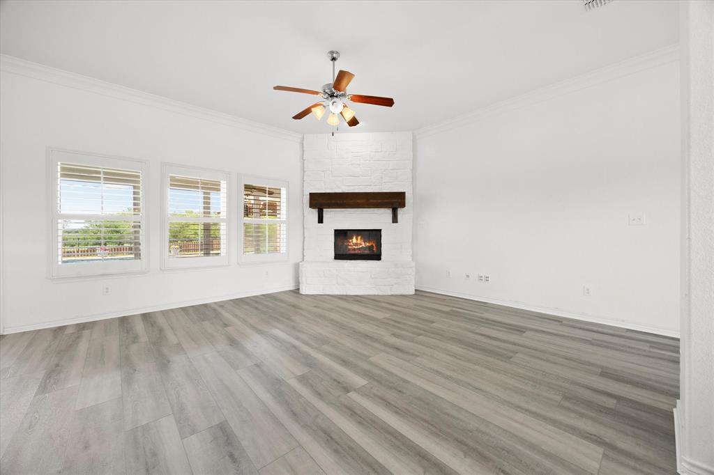 528 Hubbard Circle Nevada, TX 75173 - Photo 10 of 38 a view of an empty room with a window and fireplace