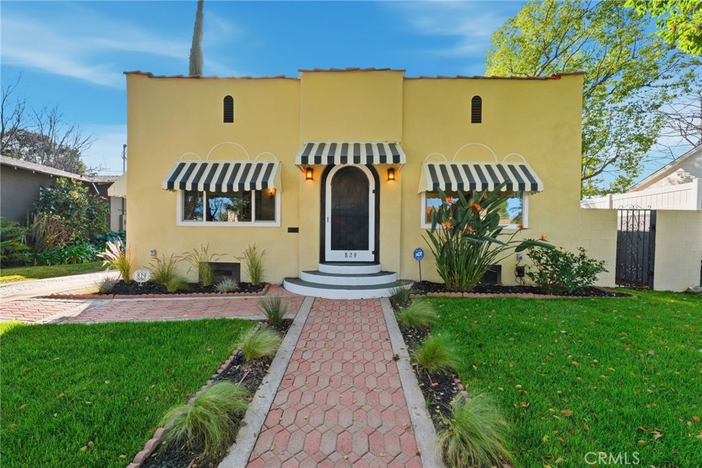 a front view of a house with garden