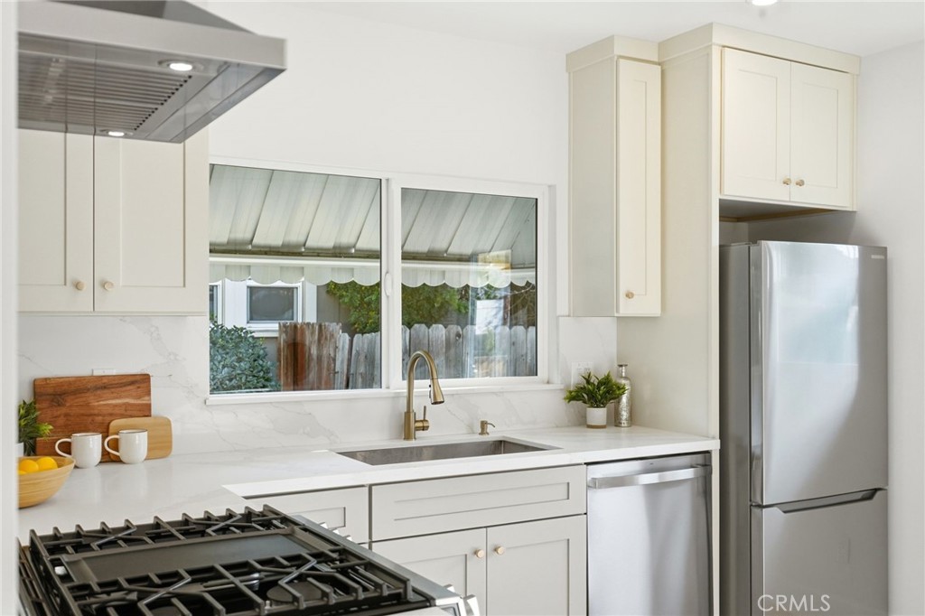 829 North Valley Street Burbank, CA 91505 - Photo 19 of 58 a kitchen with stainless steel appliances a sink stove and refrigerator