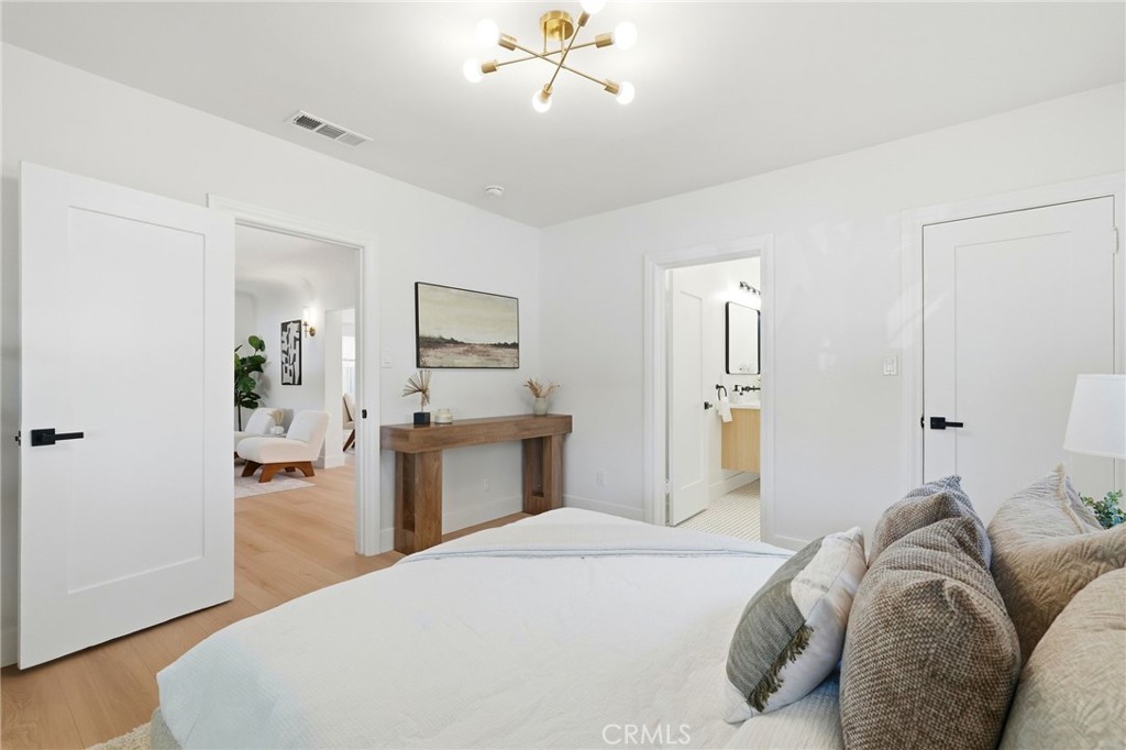 829 North Valley Street Burbank, CA 91505 - Photo 28 of 58 a bedroom with a large bed and a chandelier