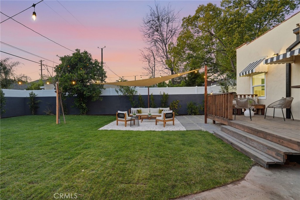 829 North Valley Street Burbank, CA 91505 - Photo 41 of 58 a view of a patio with table and chairs potted plants and a large tree