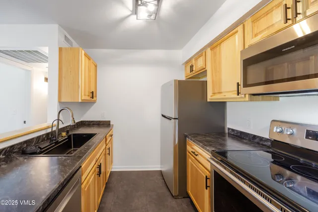 a kitchen that has a sink and a stove