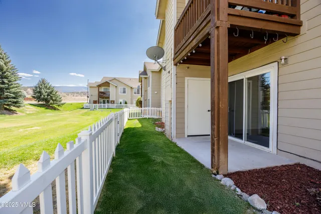 a view of a house with backyard and porch