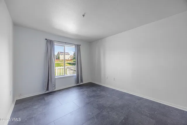 an empty room with wooden floor and closet