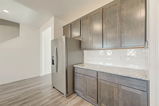 a kitchen with cabinets and stainless steel appliances