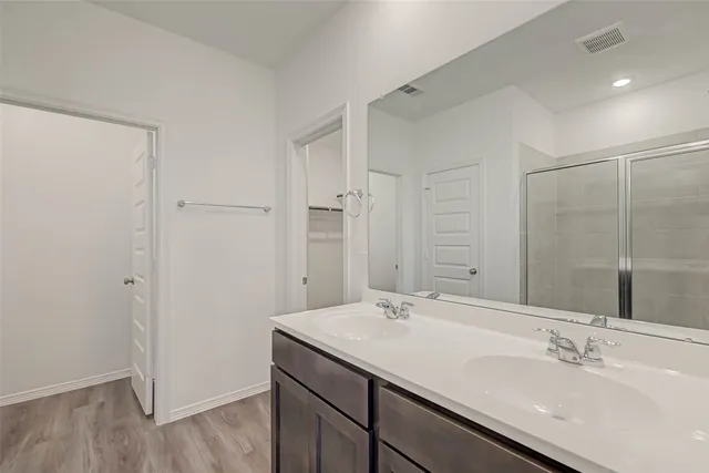 a bathroom with a glass shower door