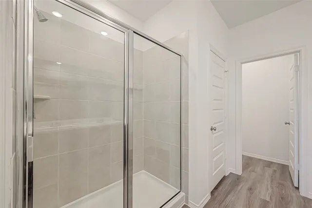 a bathroom with a double vanity sink a mirror and a shower