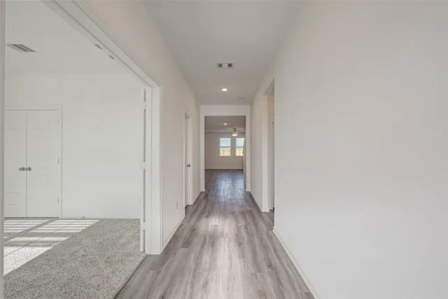 a view of hallway with wooden floor