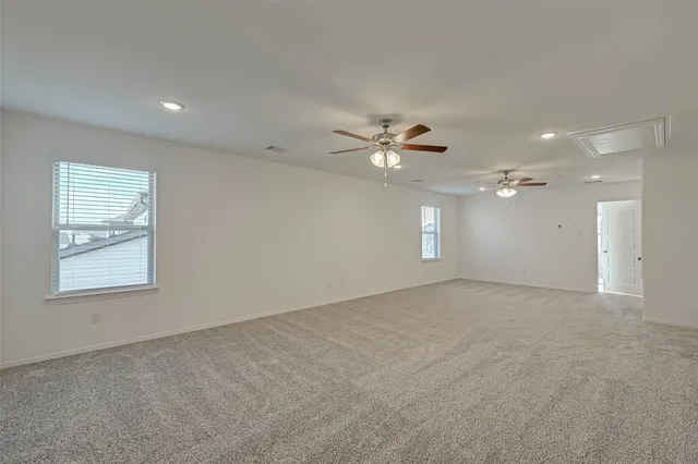 a front view of house with yard and trees in the background