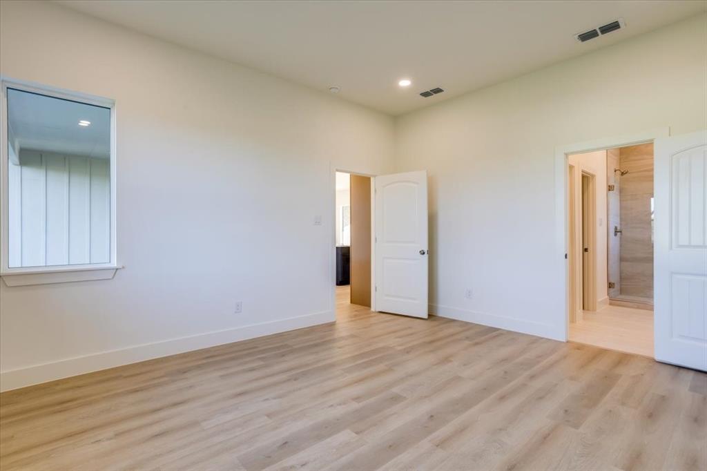 1507 Elk Creek Road Dallas, TX 75253 - Photo 17 of 40 a view of an empty room with wooden floor