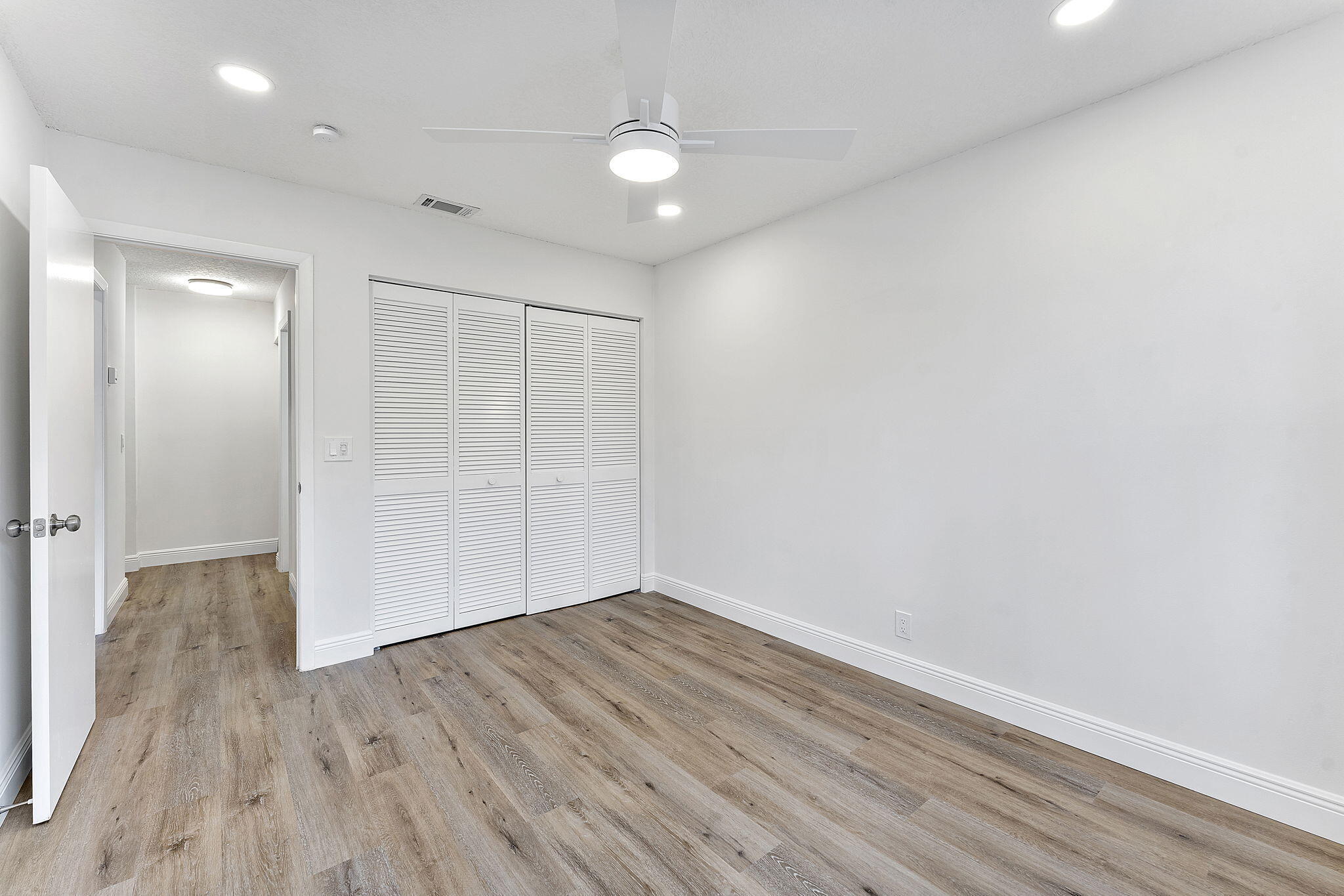 9180 Pine Springs Drive Boca Raton, FL 33428 - Photo 18 of 29 wooden floor in an empty room with a window