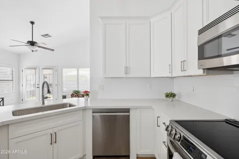 a kitchen with a sink cabinets and window