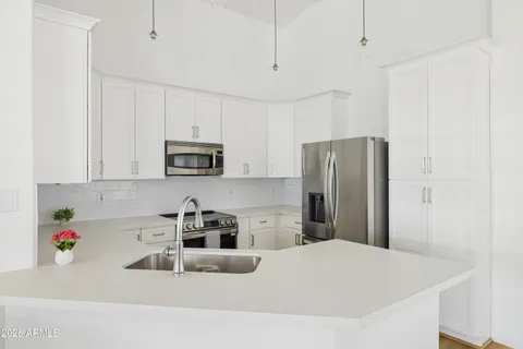 a kitchen with stainless steel appliances granite countertop a refrigerator sink and microwave