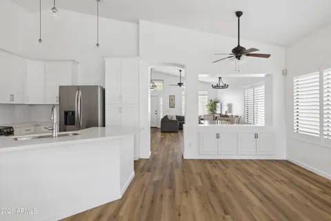 a view of a kitchen with wooden floor and window