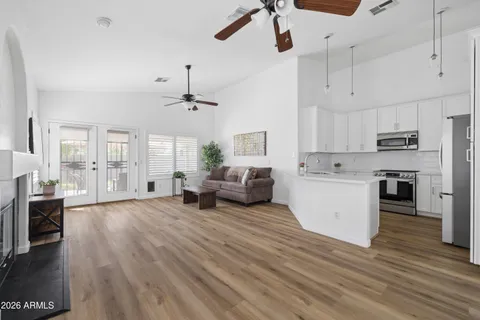a living room with furniture and kitchen view