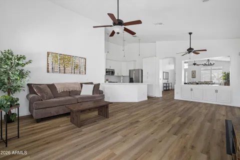 a living room with furniture and a wooden floor