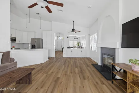 a view of kitchen and living room with wooden floor