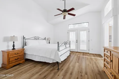 a bedroom with a bed and a chandelier