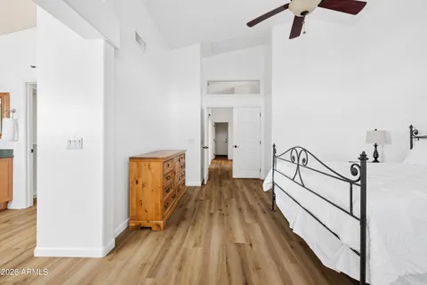 a view of a hallway with wooden floor and staircase