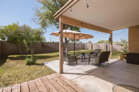 a view of a porch with a table and chairs
