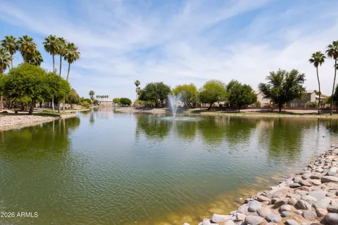 a view of a lake with houses in the background