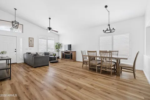 a living room with furniture wooden floor and a chandelier