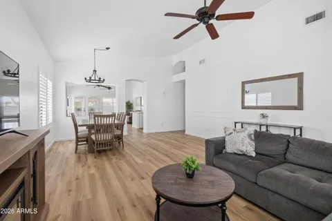 a living room with furniture and a wooden floor