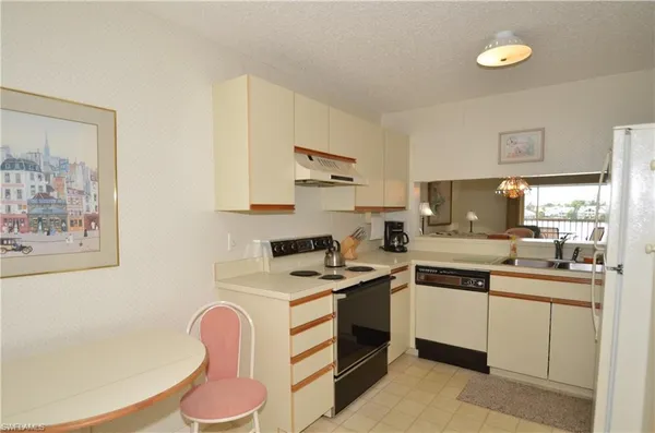 a kitchen with a sink a stove and cabinets