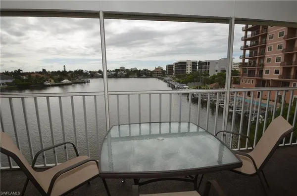 a view of a balcony with chair and city view