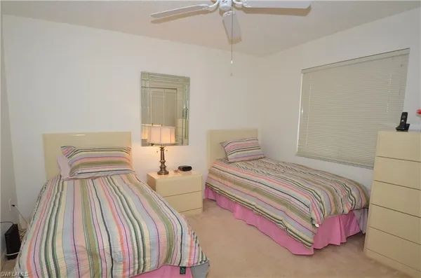 a bedroom with a bed and a lamp