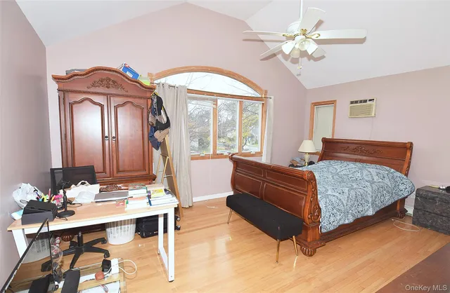 a bed sitting in a room next to a lamp