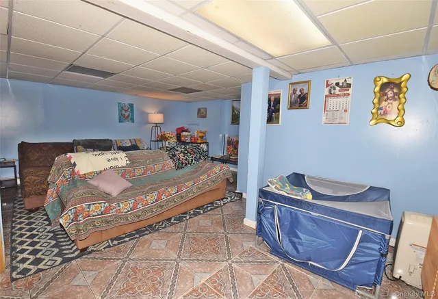 a bedroom with a bed and a flat tv screen