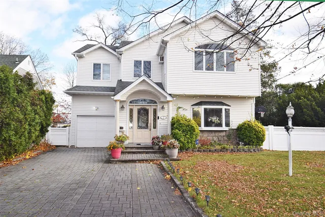 a front view of a house with a yard