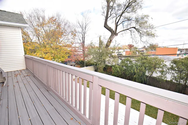 a balcony with wooden floor and fence