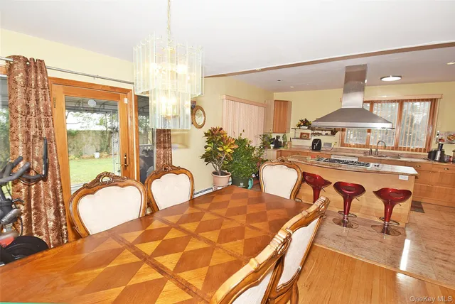 a dining room with furniture and chandelier