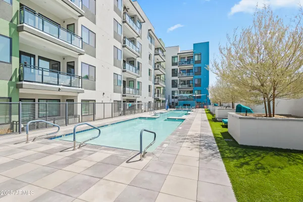 a swimming pool with outdoor seating and yard